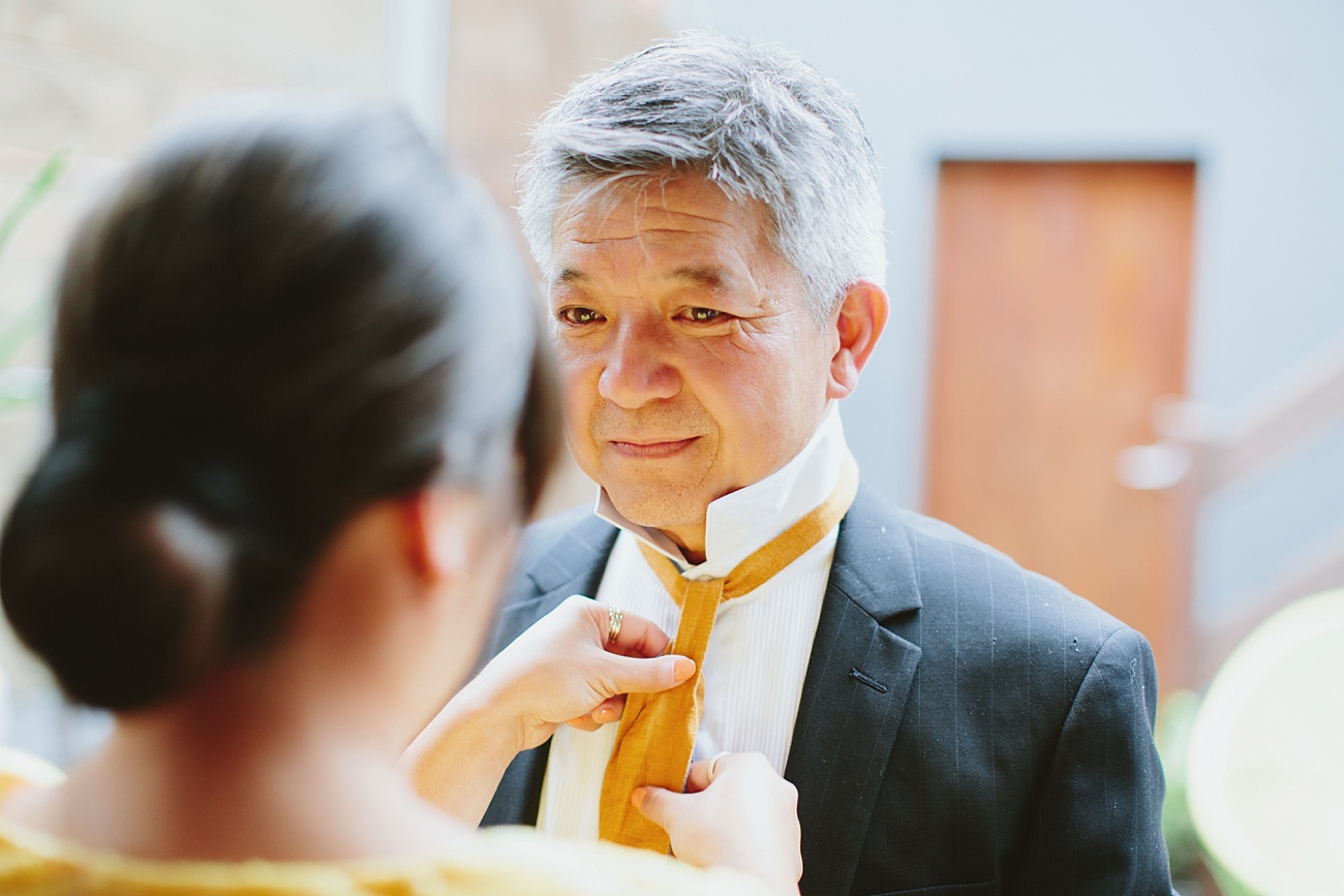 putting dad's bow tie on and getting ready to get married